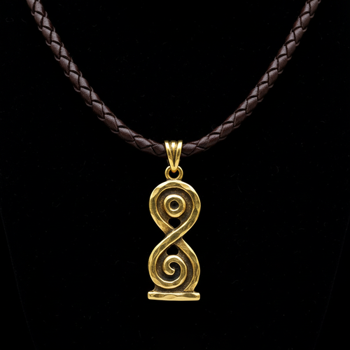 Gold Adinkra symbol pendant on dark braided leather cord against black background